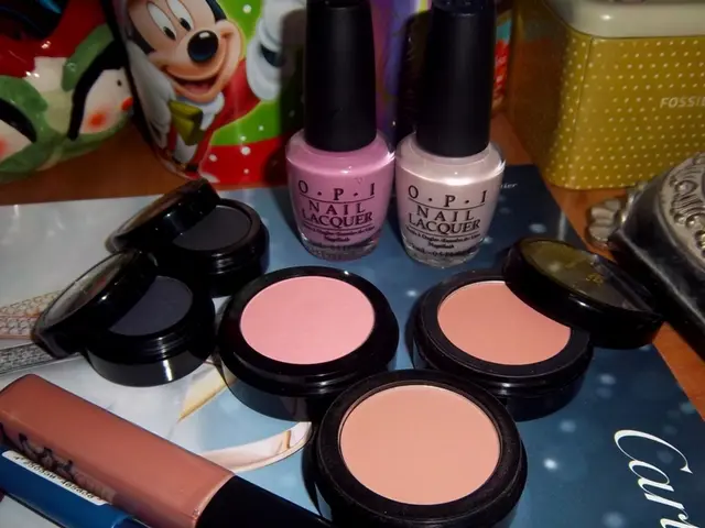 In this image, we can see makeup kit and nail polishes are on the magazine. Here we can see few...